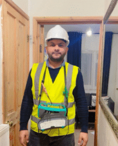 Electrician wearing safety gear and equipment.